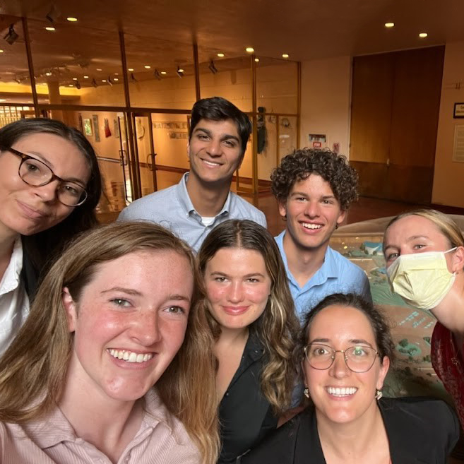 Many hands reaching toward the center in solidarity